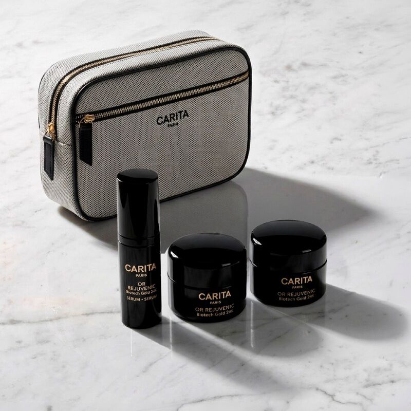 Borsa Carita e tre prodotti Or Rejuvenic in barattoli neri.​