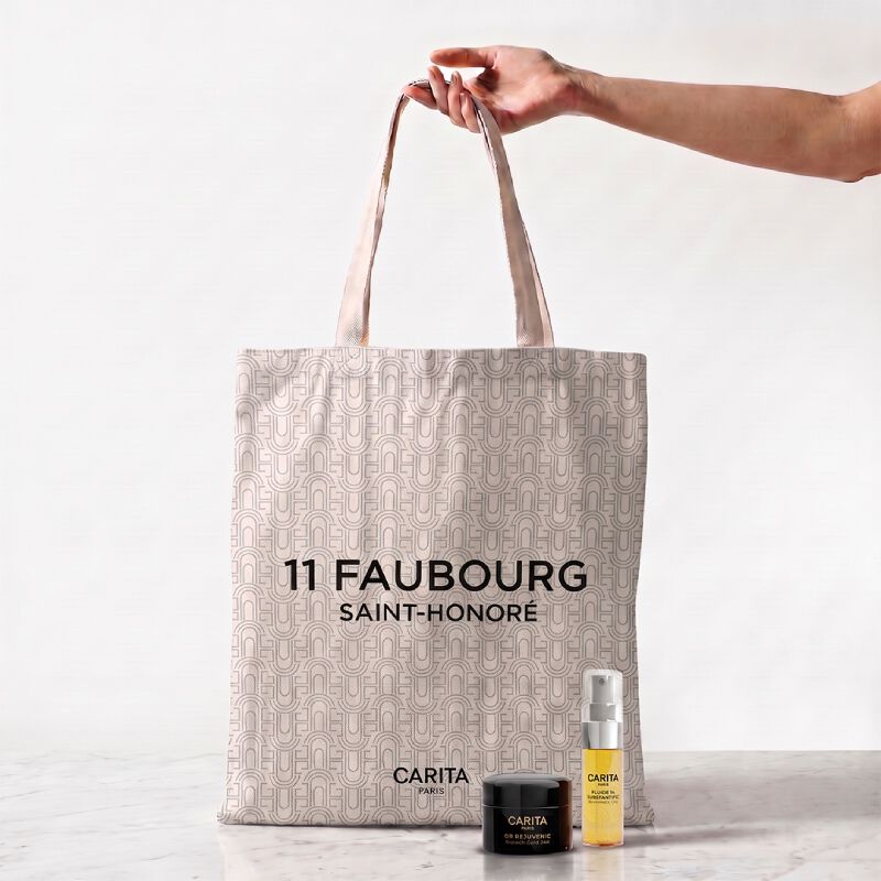 Borsa Carita e tre prodotti Or Rejuvenic in barattoli neri.​
