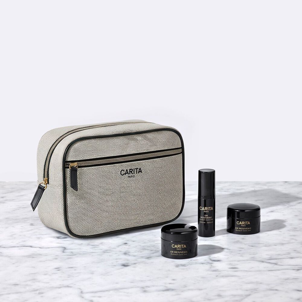 Borsa Carita e tre prodotti Or Rejuvenic in barattoli neri.​