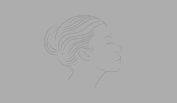 A minimalist line drawing of a woman's profile with her hair styled in a bun, set against a light gray background.